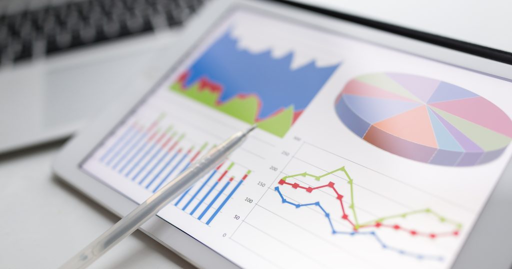 Visualization of real-time claim tracking feature in medical billing software. Dashboard display on a device showing interactive graphs and charts depicting claim statuses: pending, denied, and paid, with notification icons for updates."