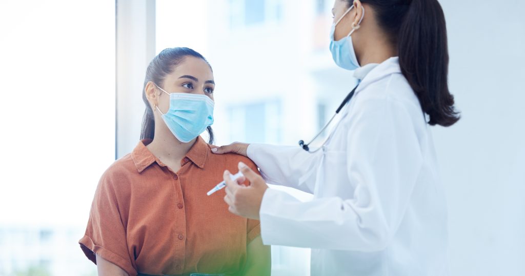 "Patient consulting with a doctor in an office, utilizing health insurance for medical services."