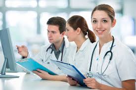 "Healthcare provider reviewing medical billing information on a computer to support accreditation and certification processes."